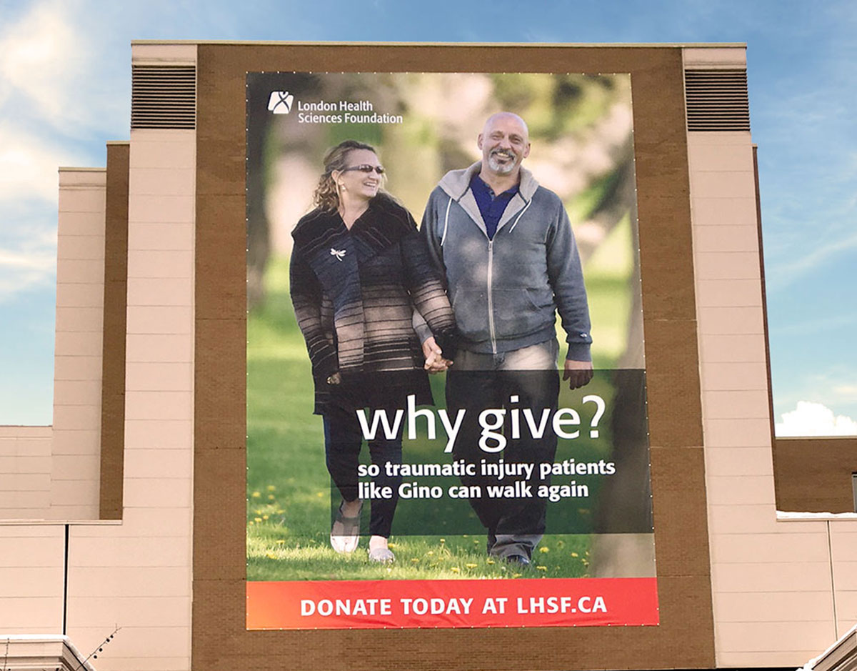 Large outdoor Why Give poster on the outside wall of London Health Sciences Centre.